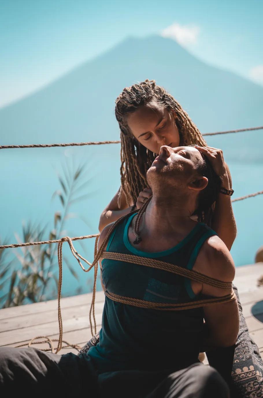 Couple practicing sensual shibari outdoors