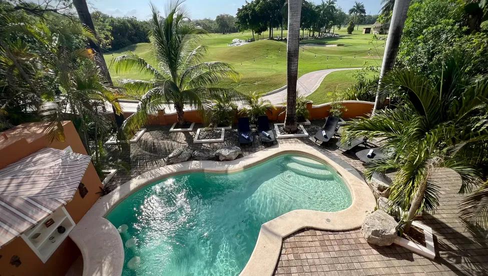 The private villa pool surrounded by palm trees